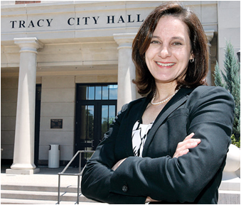 CSUEB alumna Jenny Haruyama  in front the Tracy, CA City Hall building.  She is the new Administrative Services Director. 